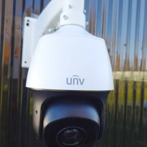 A Uniview 33x PTZ camera installed on the side of a black building