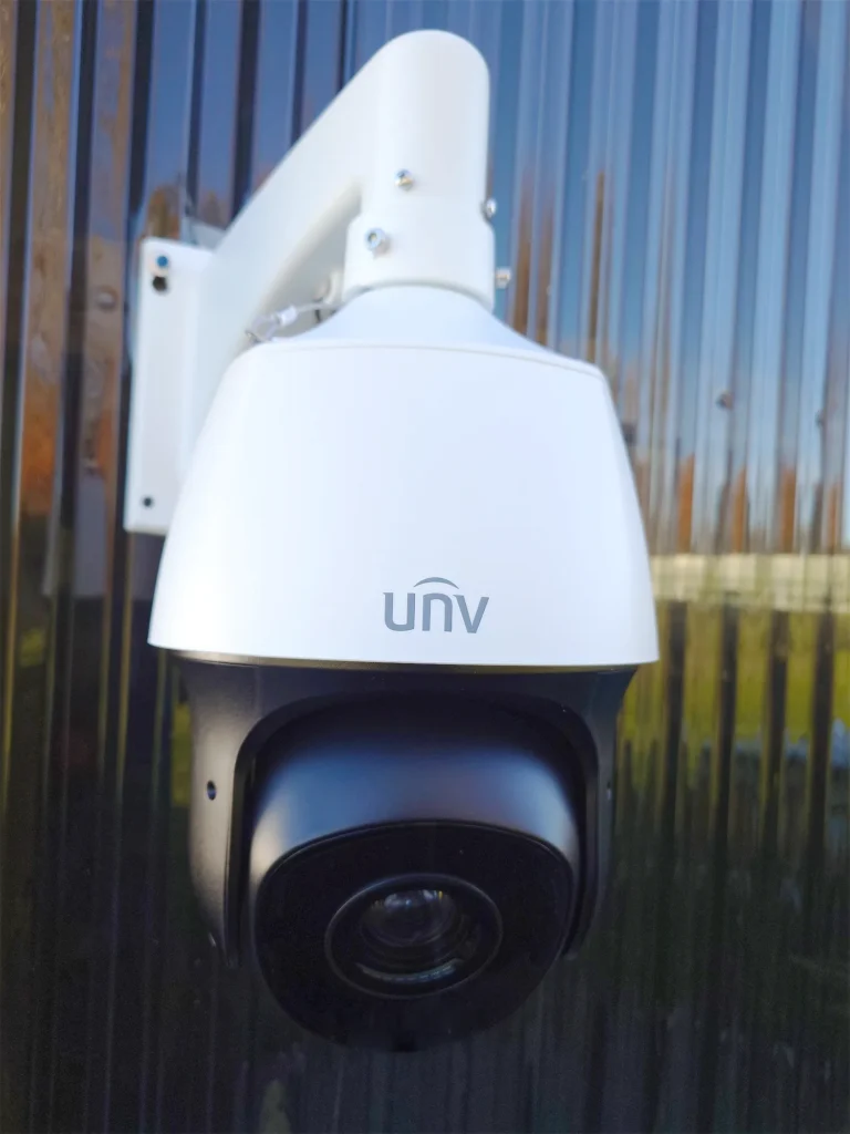 A Uniview 33x PTZ camera installed on the side of a black building