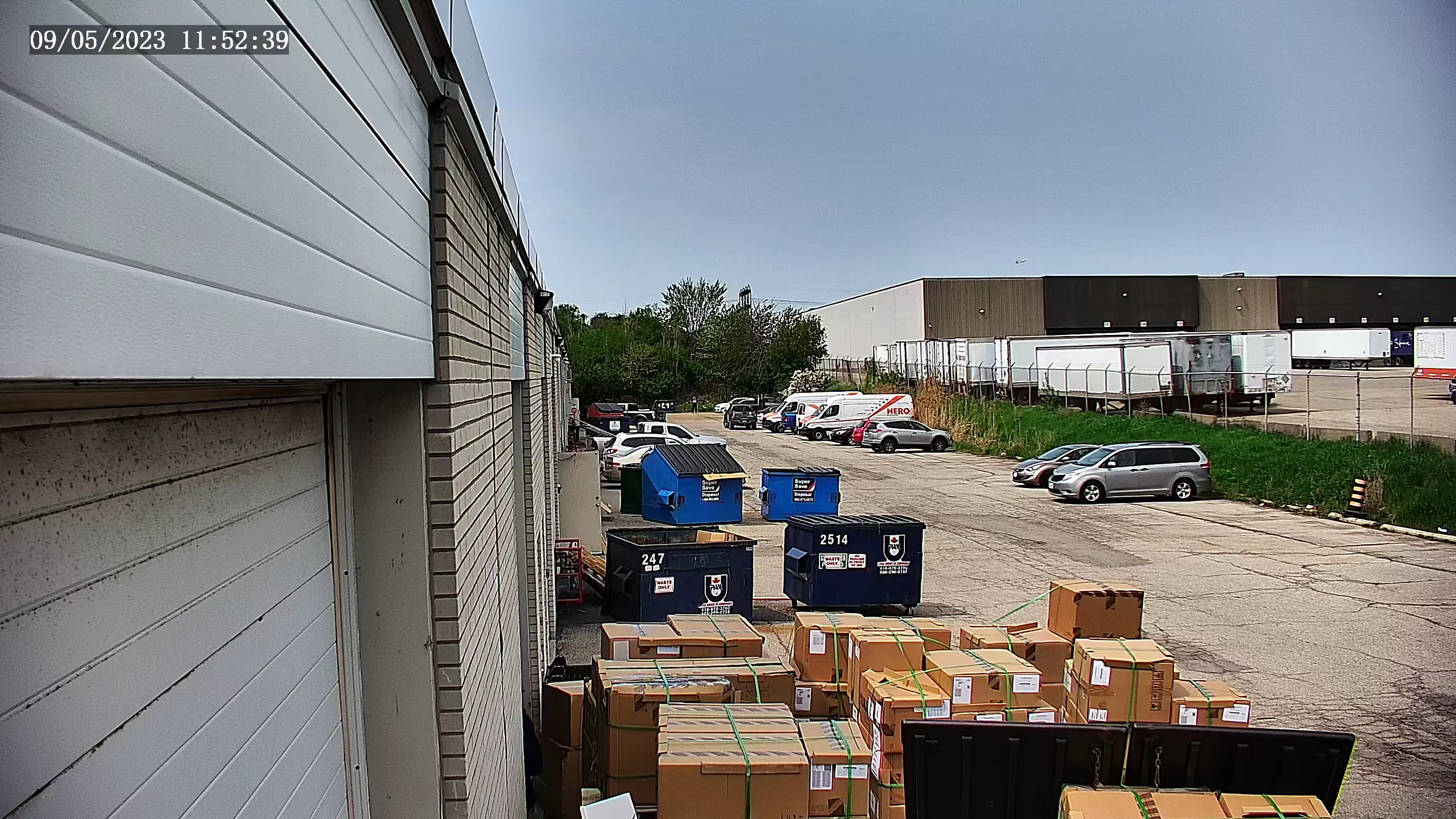 Security camera footage of the back of a commercial warehouse building