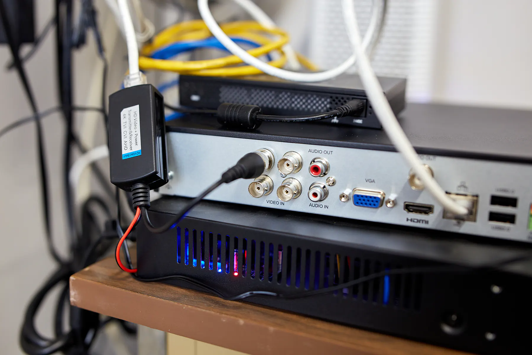 Digital video recorder in a network closet with a few cables cluttering in the background