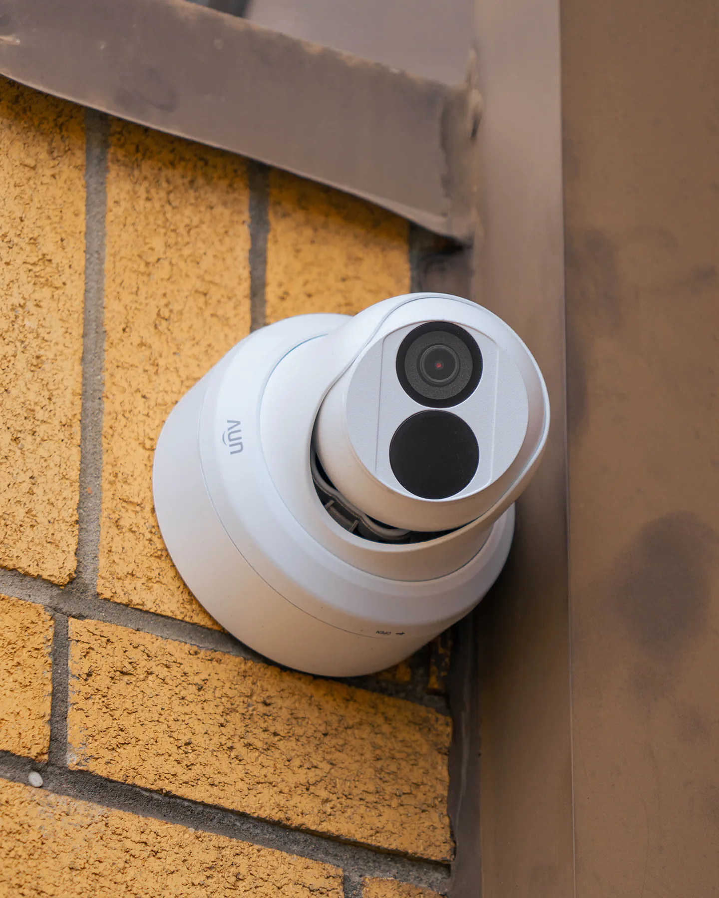 Uniview EC-T4F28M security camera mounted on a brick wall