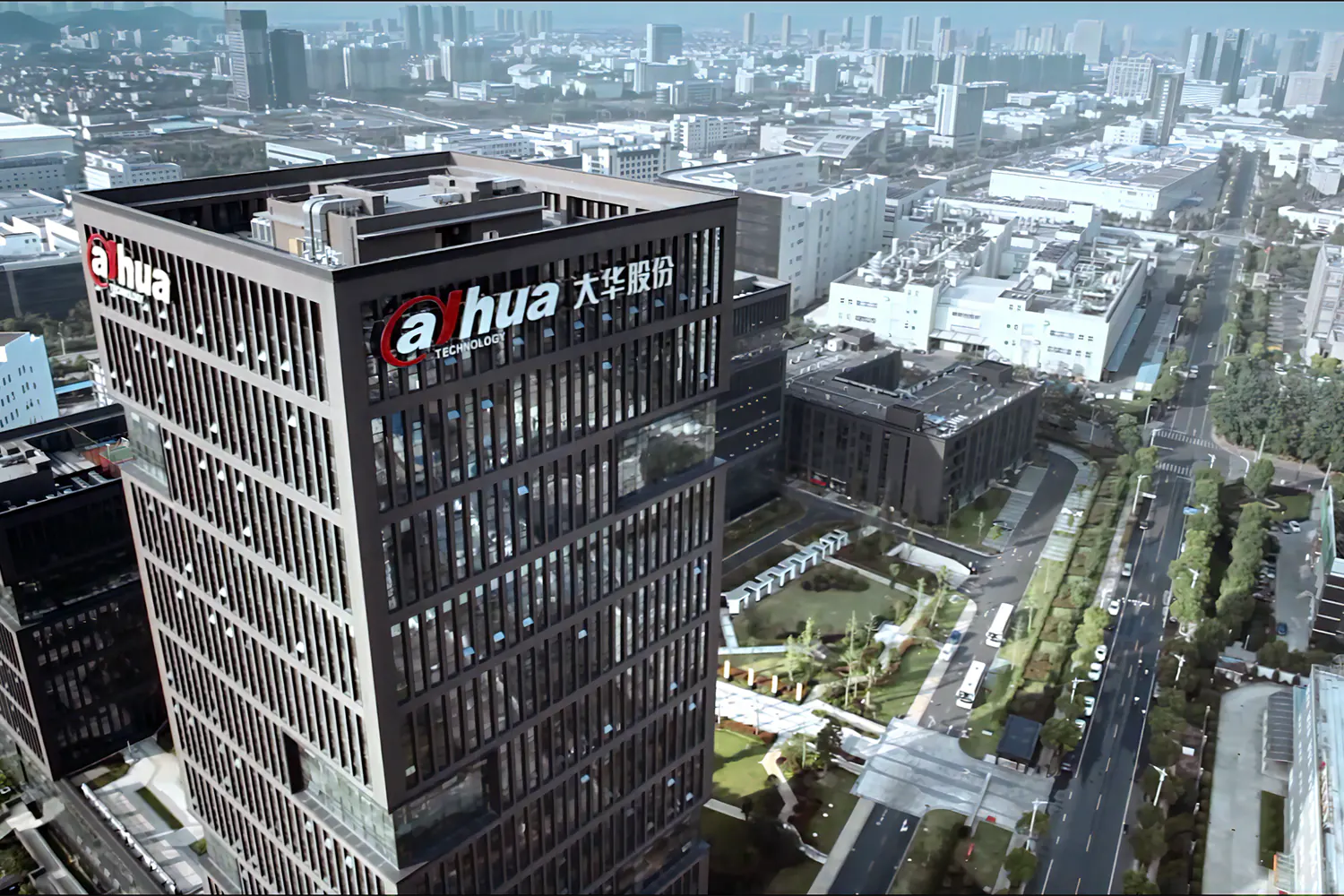 A large skyscraper office building with the Dahua Technology logo on the side. A busy city in the background.