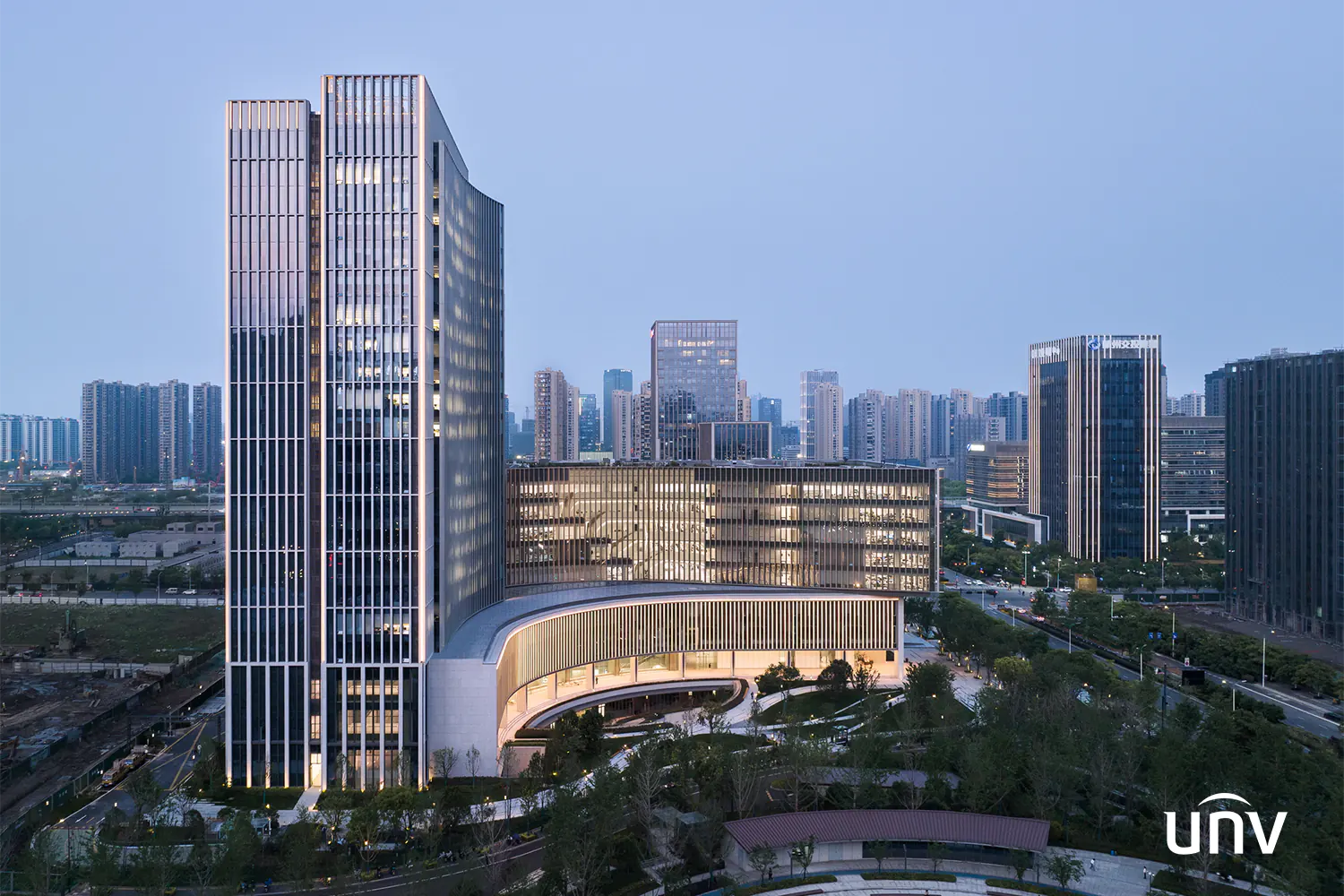 Uniview's corporate headquarters in Hangzhou City. A large, well lit skyscraper with a modern design.