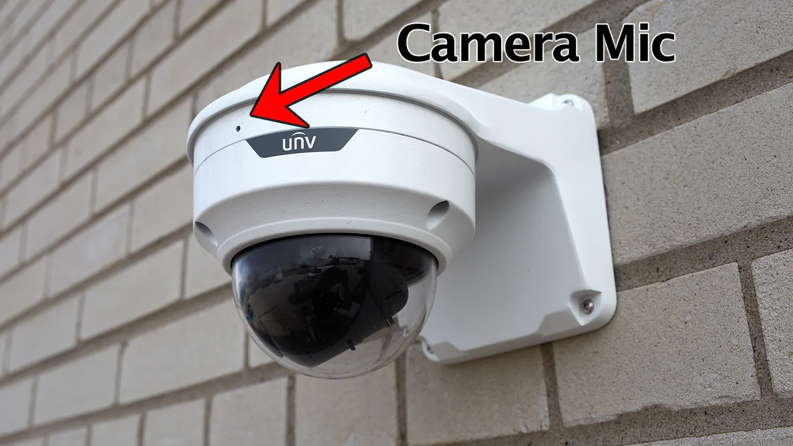 A security camera mounted outdoors on a concrete wall