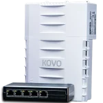 A black rectangular box with five RJ45 ports on it, with a larger white plastic enclosure behind it.