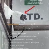 A poster depicting a Uniview 8MP Varifocal bullet camera mounted on the side of a building with snow falling in the background. The poster also lists the camera's features, such as eight megapixel resolution and a 2.8 to 12mm varifocal lens.
