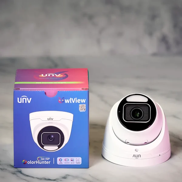 A Uniview OwlView Plus security camera on a white marble table along with the retail box of the camera beside it.