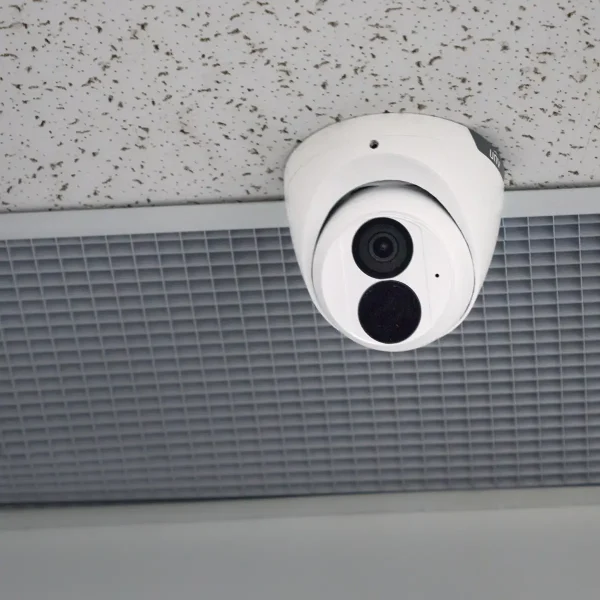 A Uniview 8MP turret camera mounted on a drop ceiling with a vent in the background