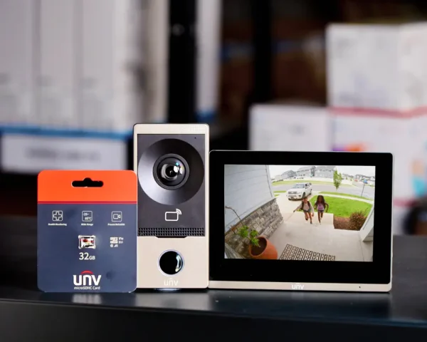 Uniview Intercom and 7-inch touchscreen on a shelf viewing the front door where two children are coming back from school