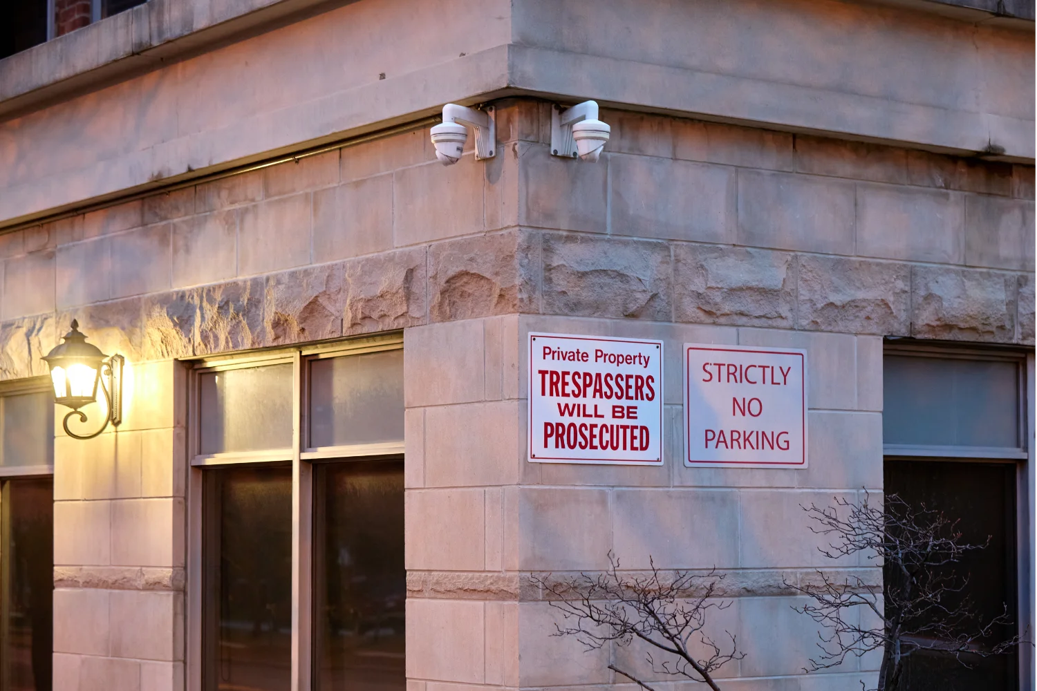 Two Hikvision security cameras facing in opposite directions, monitoring a condo building in Toronto