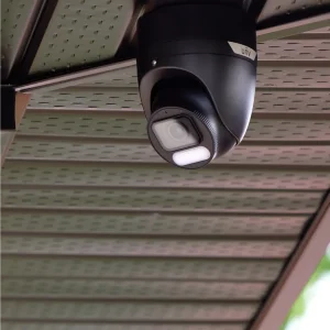 A black Uniview security camera installed into the soffit of a home