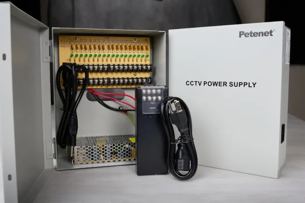 A power supply box that provides 12V DC power to security cameras, made by Petenet