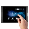 An indoor touchscreen monitor made by Akuvox, with a person's hand tapping the screen.